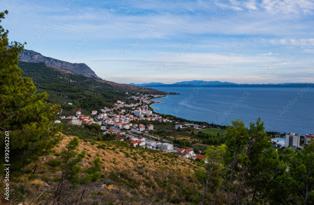The Makarska Riviera is a part of the Croatian coast of the Adriatic Sea. Top view on Tucepi at sunset time. September 2020