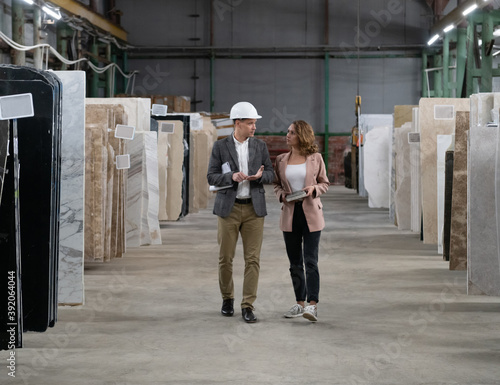 Workers walking and talking in warehouse