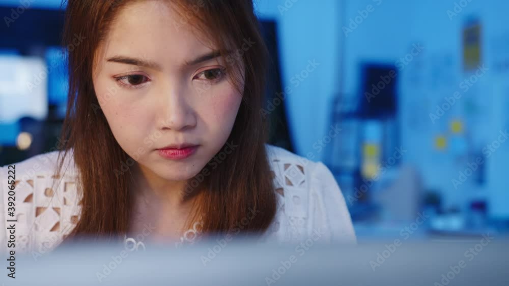 Freelance Asia women using laptop hard work at new normal home office. Working from house overload at night, remotely work, self isolation, social distancing, quarantine for corona virus prevention. Freelance Asia women using laptop hard work at new normal home office. Working from house overload at night, remotely work, self isolation, social distancing, quarantine for corona virus prevention.