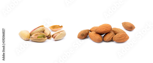  Pile of roasted pistachios and almonds isolated on white background.