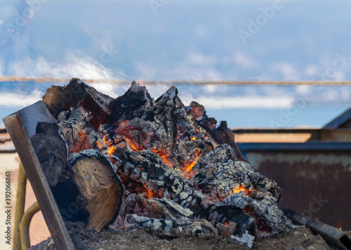 Malaga, Spain - November 01, 2020. Wood fire on the beach. Typical wood fire on the beach in Malaga to make the rich sardine spit.