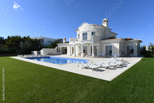 Exterior of luxury Holiday Villa with blue sky and beautiful swimming pool