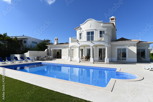 Exterior of luxury Holiday Villa with blue sky and beautiful swimming pool © rocklights