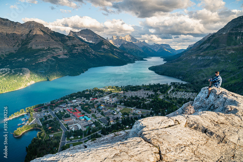 Hiker Watching the Sunset Over Waterton National Park in Alberta photo