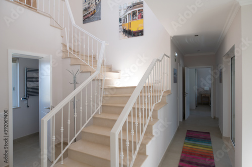 Staircase with metal railings in a home with ceramic tiled floors
