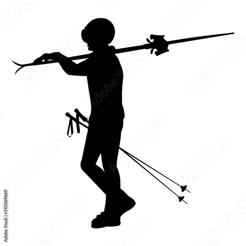 Silhouette of a girl standing with skis and ski poles