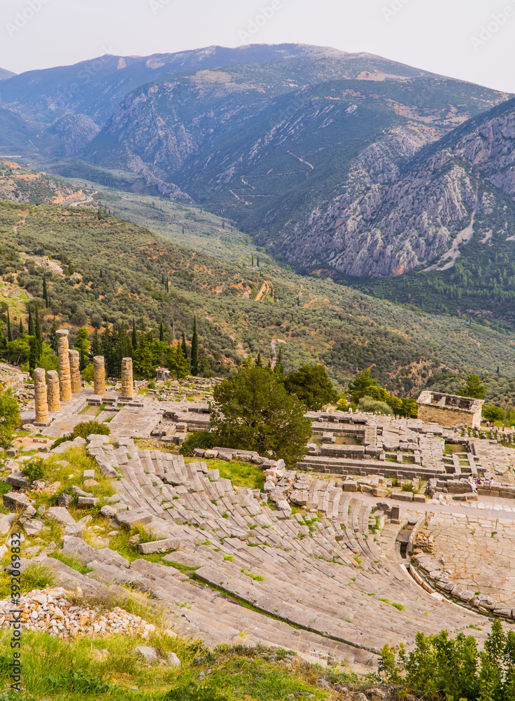 Vertical shot of the ancient theater of Delphi, Greece with mountains in the background