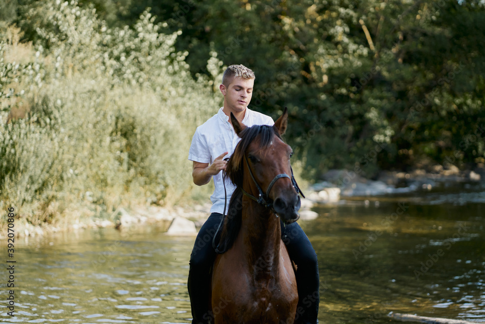 Portrait of a young blond man riding a horse over a river Portrait of a young blond man riding a horse over a river