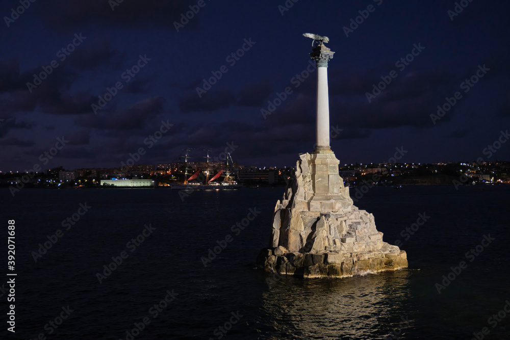 The Monument to the Sunken Ships in Sevastopol Bay, illuminated in the evening. The symbol of the city of Sevastopol, on the Crimean peninsula. The Monument to the Sunken Ships in Sevastopol Bay, illuminated in the evening. The symbol of the city of Sevastopol, on the Crimean peninsula.
