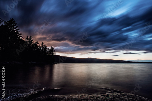 long exposure of clearing storm and sunset over Bald Mountain Pond photo