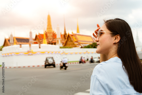 Young Woman traveling to Grand palace and Wat phra keaw at sunse photo