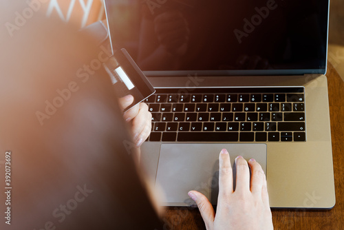 Woman hands holding credit card and using laptop. Online shoppin photo