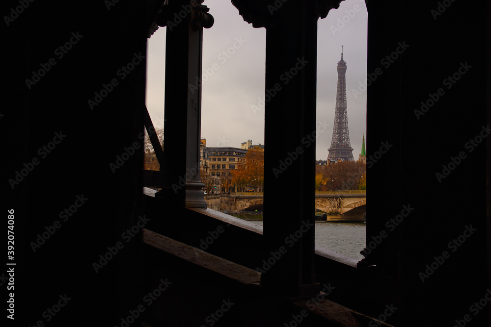 Paris, France - November 29, 2019 - Under a bridge the view of the Eiffel Tower
