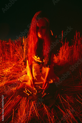 Woman in halloween witch costume divination on the bones