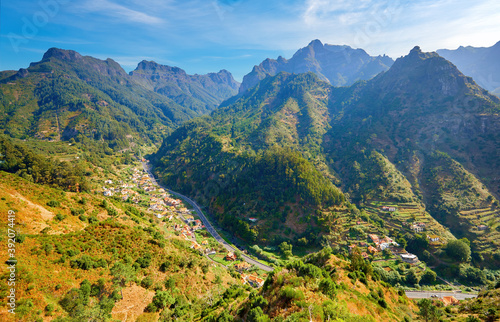 Traveling Madeira. View on valley with houses and winding road against steep peaks from Encumeada hiking path. Portugal. © Martin Mecnarowski
