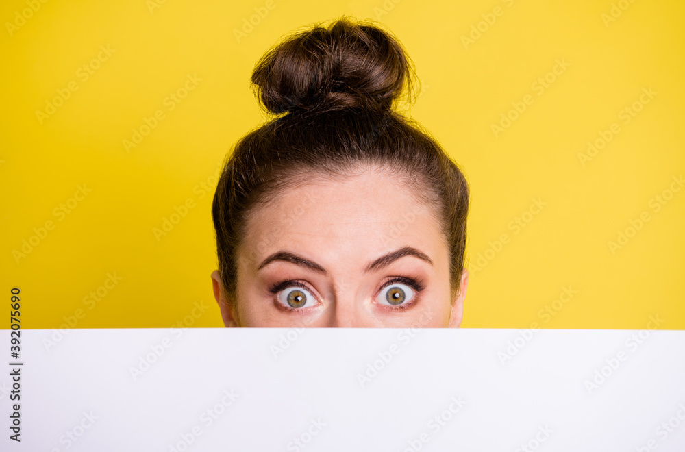 Photo of amazed young lady cover face look card board news proposition isolated on yellow color background Photo of amazed young lady cover face look card board news proposition isolated on yellow color background