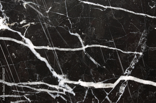 White pattern natural on black marble texture.