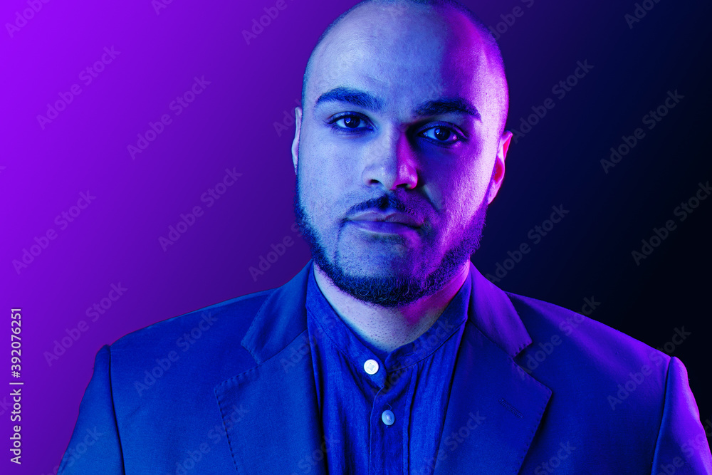 Serious thoughtful black guy portrait in neon light Serious thoughtful black guy portrait in neon light