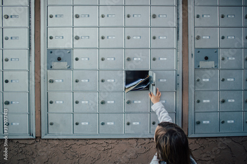 Child unlocks and opens door to cluster mailbox unit