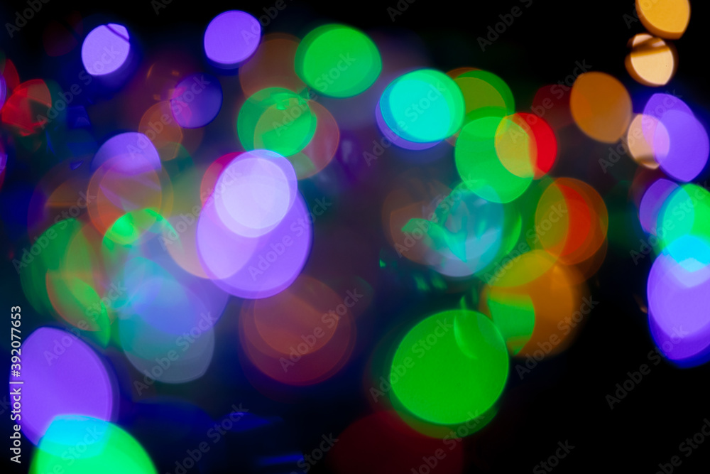Multicolored spots of light against black background Multicolored spots of light against black background