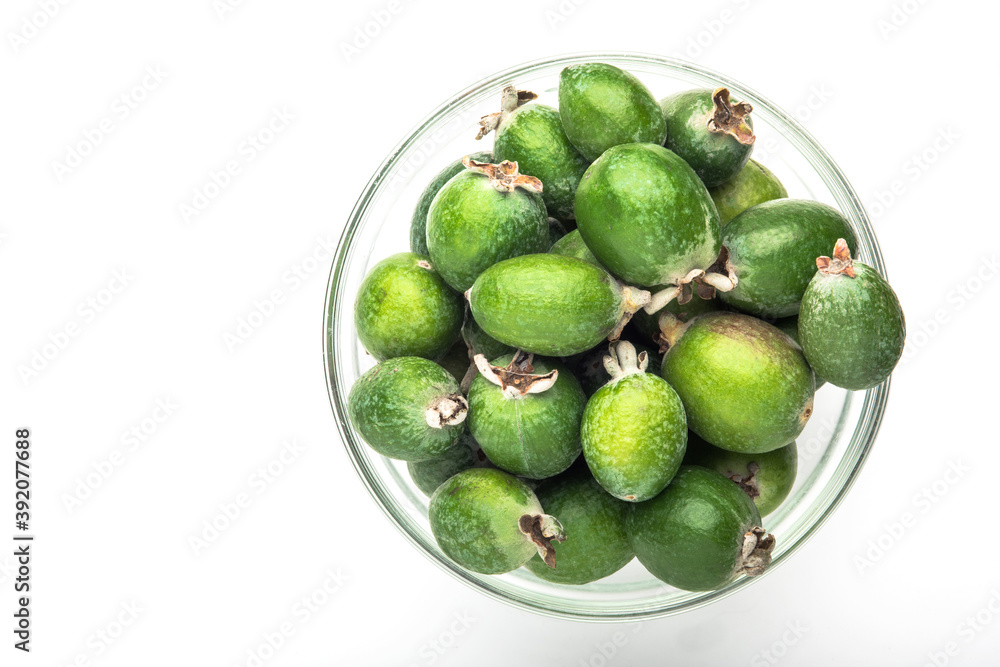 Green feijoa fruit in a glass dish, isolated on a white background. Tropical feijoa fruit. Set of ripe feijoa fruits. the view from the top. Space for copying. Organic food. Vegetarian food. Food stoc Green feijoa fruit in a glass dish, isolated on a white background. Tropical feijoa fruit. Set of ripe feijoa fruits. the view from the top. Space for copying. Organic food. Vegetarian food. Food stoc