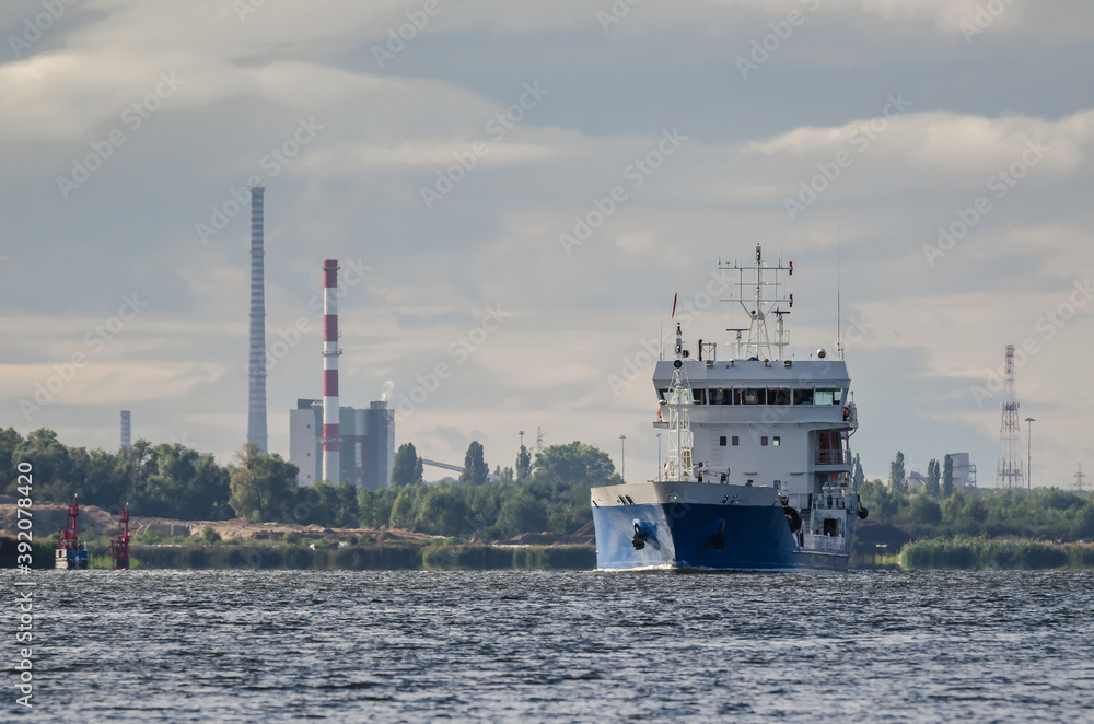 MERCHANT VESSEL - Ship on the background of the coast with industrial chimneys
