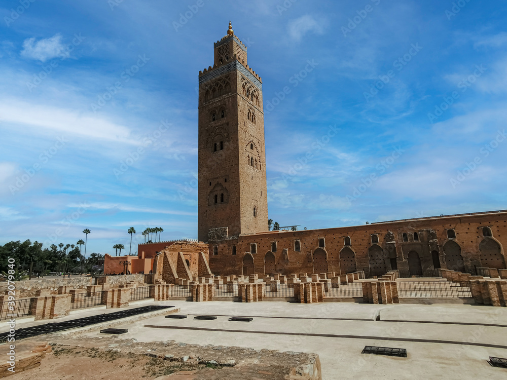 view of the famous tower Kutubiyya Mosque in Marrakesh with its temple in the foreground.