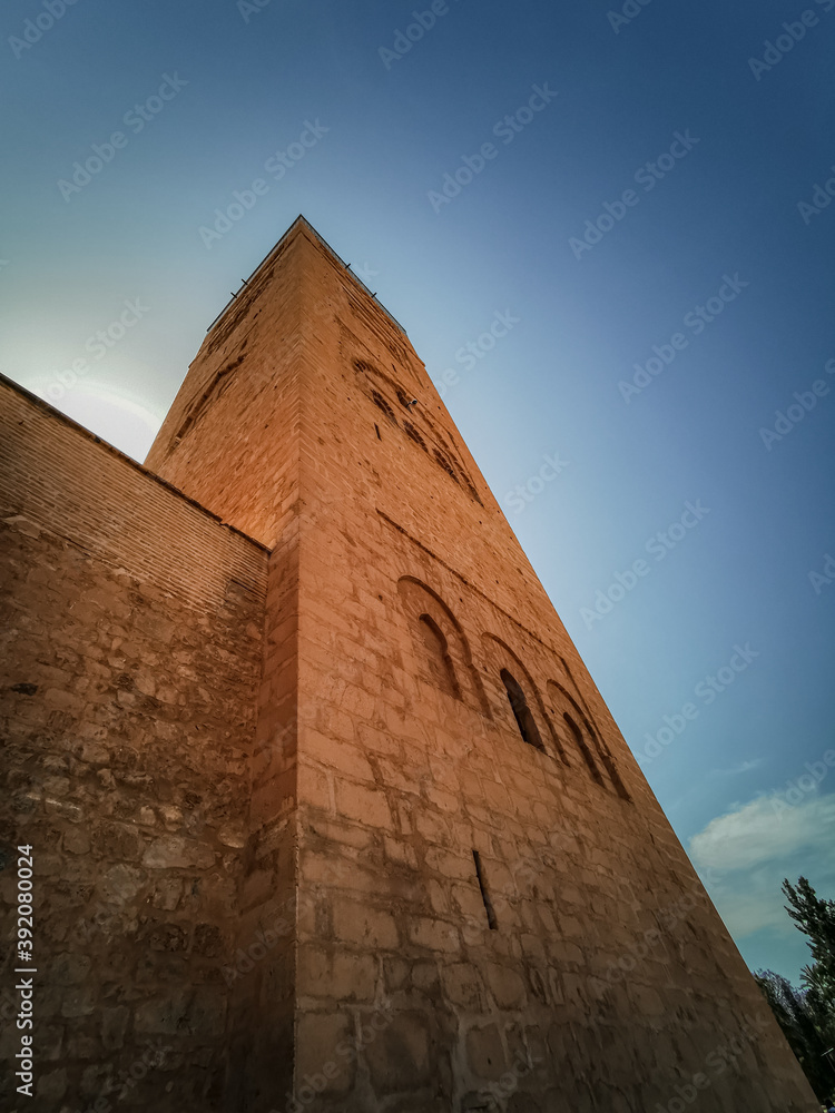 Low angle ultra wide shot town view of Koutoubia mosque's minaret/tower in Marrakesh with a clear sky