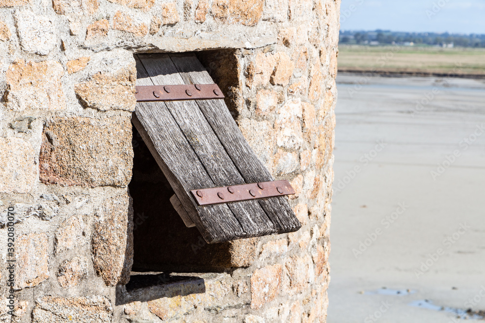 Open wooden shutter in a tower in the ramparts of Mont Saint-Michel