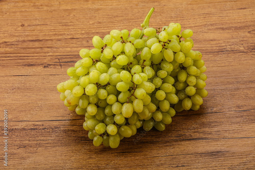 Green grape branch over background Green grape branch over background