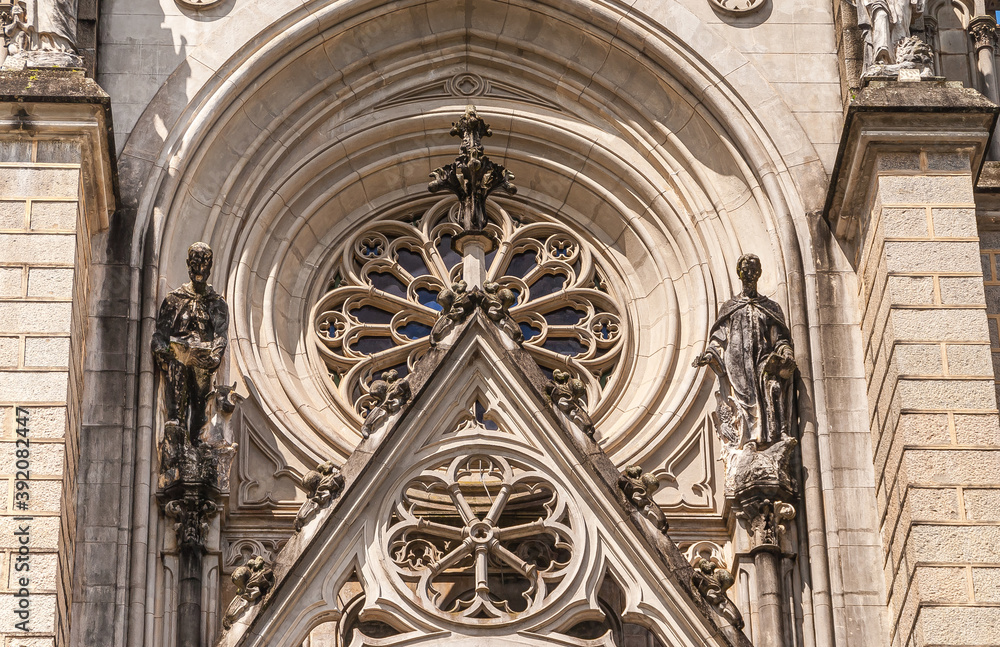 Petropolis, Brazil - December 23, 2008: Architectural detail of window at Cathedral of Saint Peter of Alcantara, shows rose window and statues.