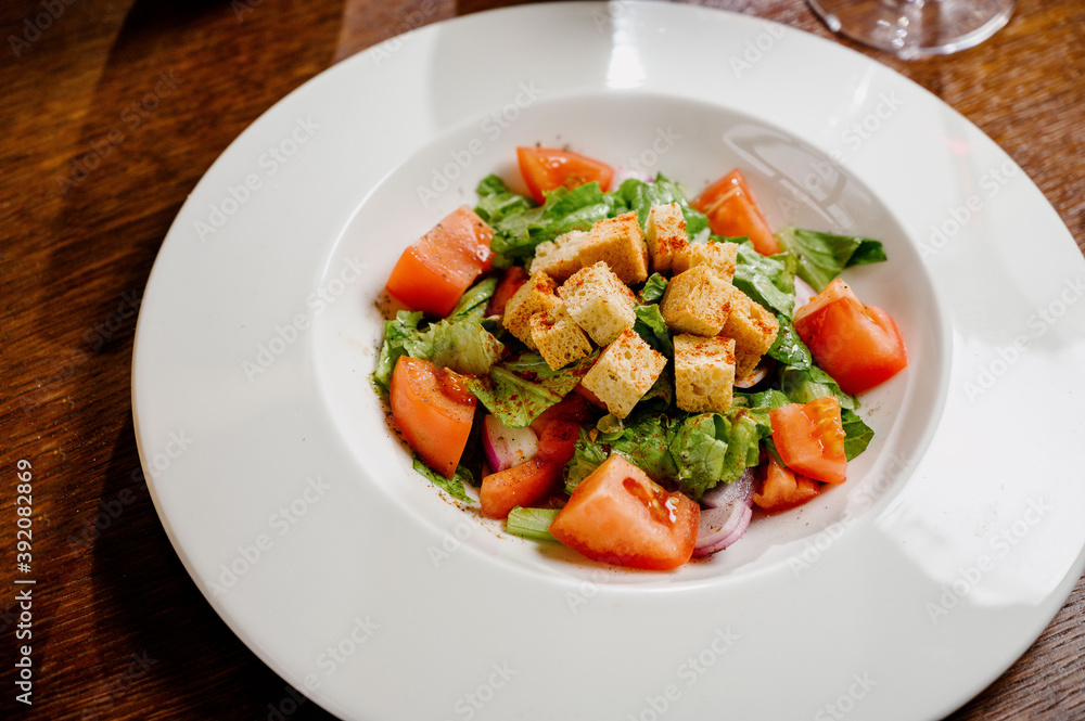 Caesar salad with croutons, quail eggs, cherry tomatoes and grilled chicken in wooden table Caesar salad with croutons, quail eggs, cherry tomatoes and grilled chicken in wooden table