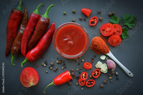 Hot pepper and sauce on a gray background.