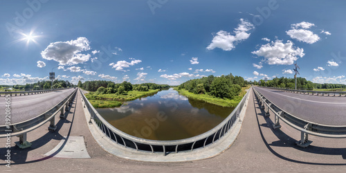 full seamless spherical hdri panorama 360 degrees on concrete bridge with solar panels near asphalt road across river in sunny summer day in equirectangular projection, AR VR virtual reality content