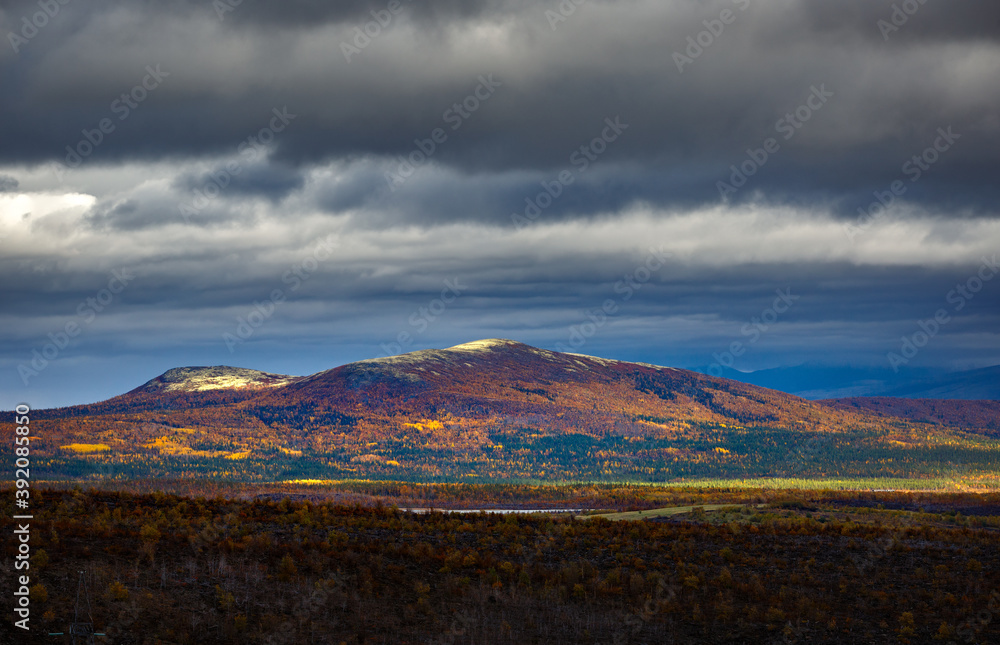 Clouds over the lake in the mountainous part of the tundra in autumn.