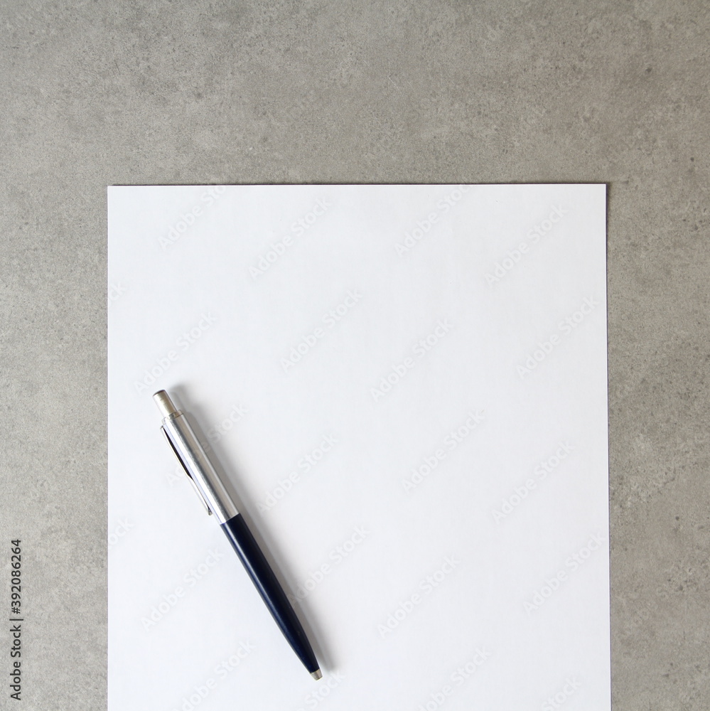 Template of white paper with a ballpoint pen on light grey concrete background. Concept of new idea, business plan and strategy, empty space for text Template of white paper with a ballpoint pen on light grey concrete background. Concept of new idea, business plan and strategy, empty space for text
