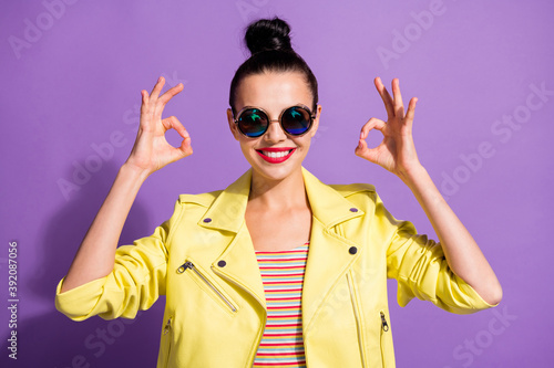 Photo of young cheerful smiling attractive girl woman female showing sign okay two hands isolated on violet color background photo