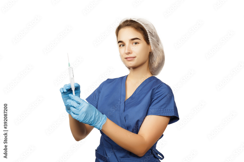 A female doctor in blue gloves and a surgical gown holds a syringe with a drug in her hands in front of her. Health concept. Anesthesia or vaccine for virus and disease. Hospital medical care. A female doctor in blue gloves and a surgical gown holds a syringe with a drug in her hands in front of her. Health concept. Anesthesia or vaccine for virus and disease. Hospital medical care.