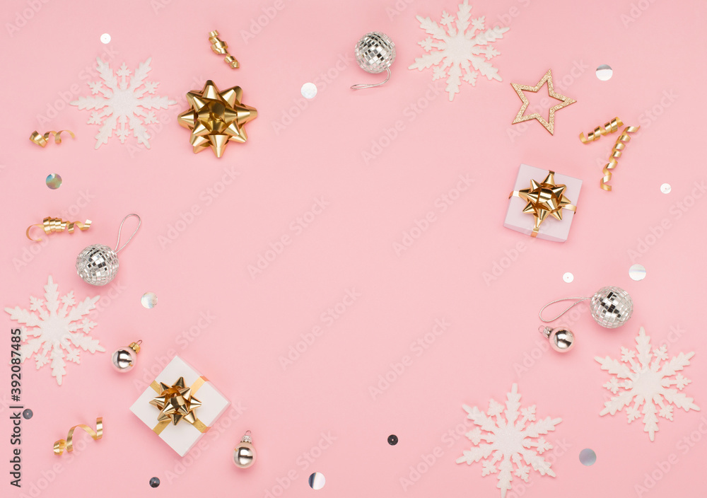 Christmas card - gold and silver decorations, festive gifts, snowflakes on pink background. Xmas, winter, new year concept.