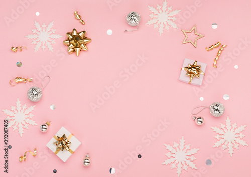 Christmas card - gold and silver decorations, festive gifts, snowflakes on pink background. Xmas, winter, new year concept. © Iuliia Metkalova