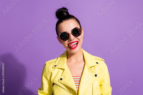 Portrait of positive youth lady lick tongue lips isolated over violet color background