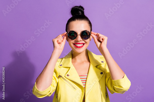 Portrait of pretty youth girl toothy smile in camera touch cool specs isolated over violet color background © deagreez