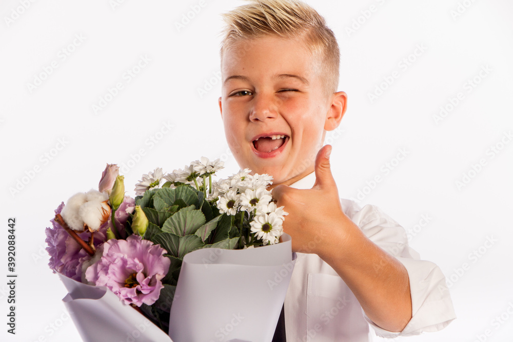Cheerful blond fashionable boy gives bouquet and thumbs up on white studio background, delivery flowers, Spring Womens Day Cheerful blond fashionable boy gives bouquet and thumbs up on white studio background, delivery flowers, Spring Womens Day