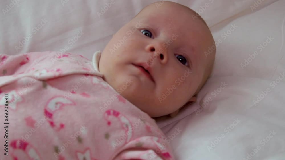bald baby in bed,beautiful baby in the crib lies and yawns bald baby in bed,beautiful baby in the crib lies and yawns