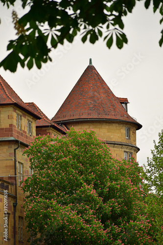 Tower of an old building with a roof covered with tiles