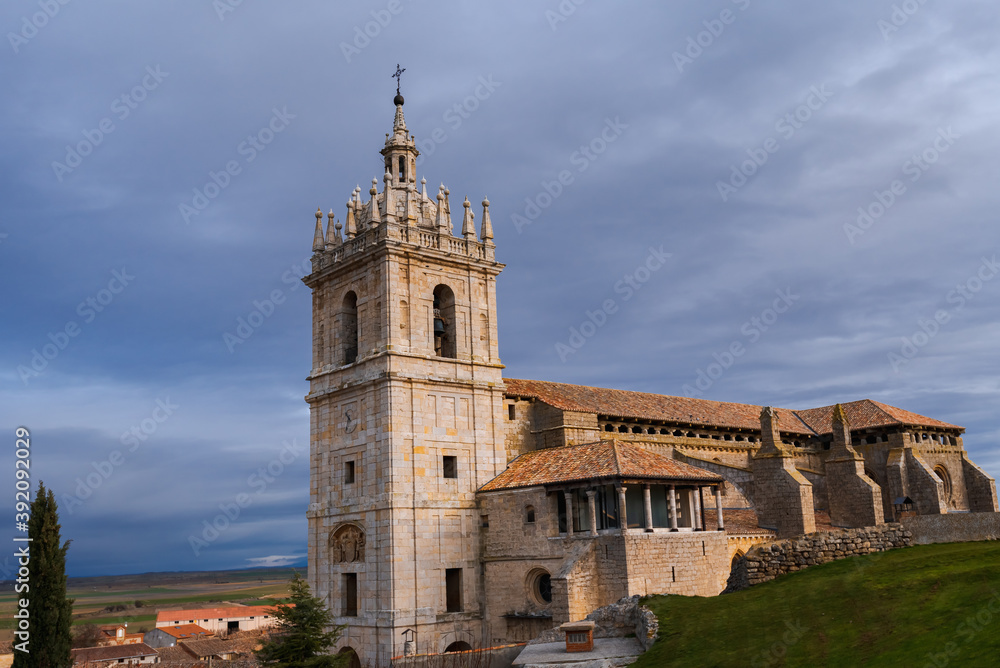 old gothic style catholic church lateral view with a dramatic sky in palencia, spain