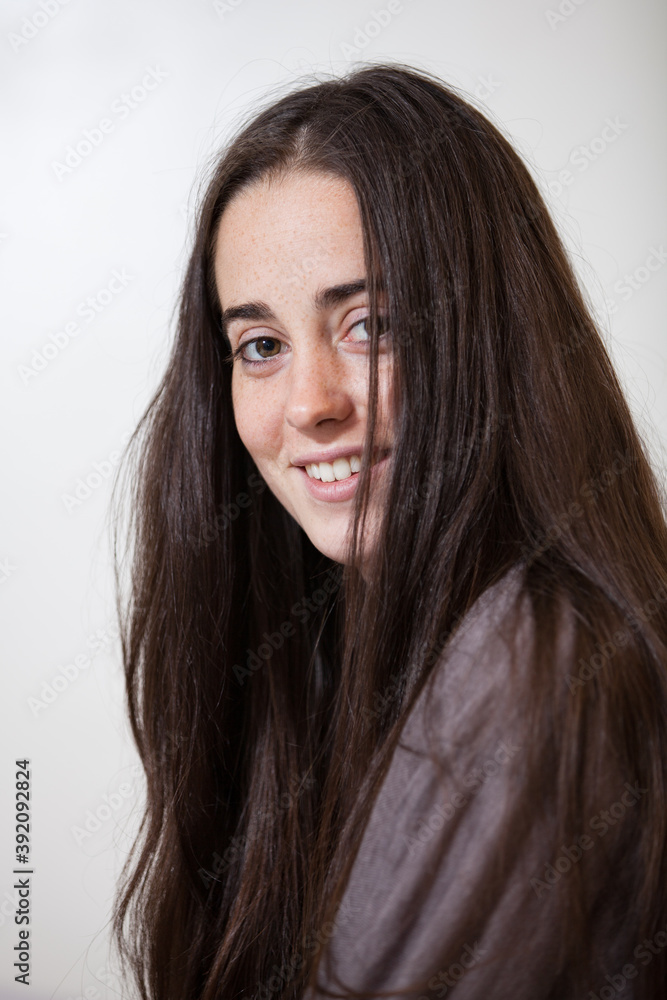 Portrait of a young and sweet natural woman without makeup with long brown hair Portrait of a young and sweet natural woman without makeup with long brown hair