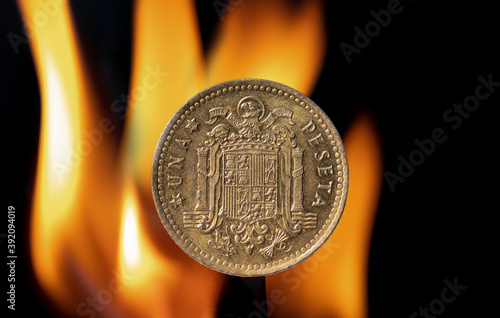 Old Peseta coin with the coat of arms of Franco's Spain formed by the eagle of San Juan with flames behind photo