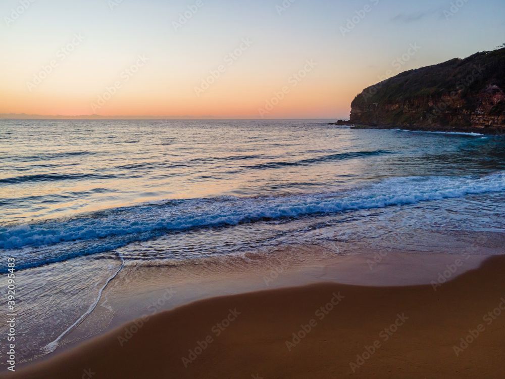 Fototapeta premium Hazy sunrise seascape with low swell