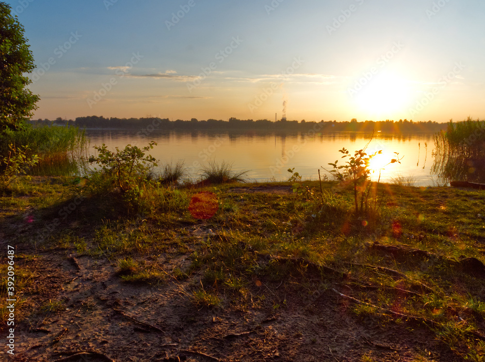 Setting sun in nature environment. Photo with a greatly exposed optical flare. Setting sun in nature environment. Photo with a greatly exposed optical flare.
